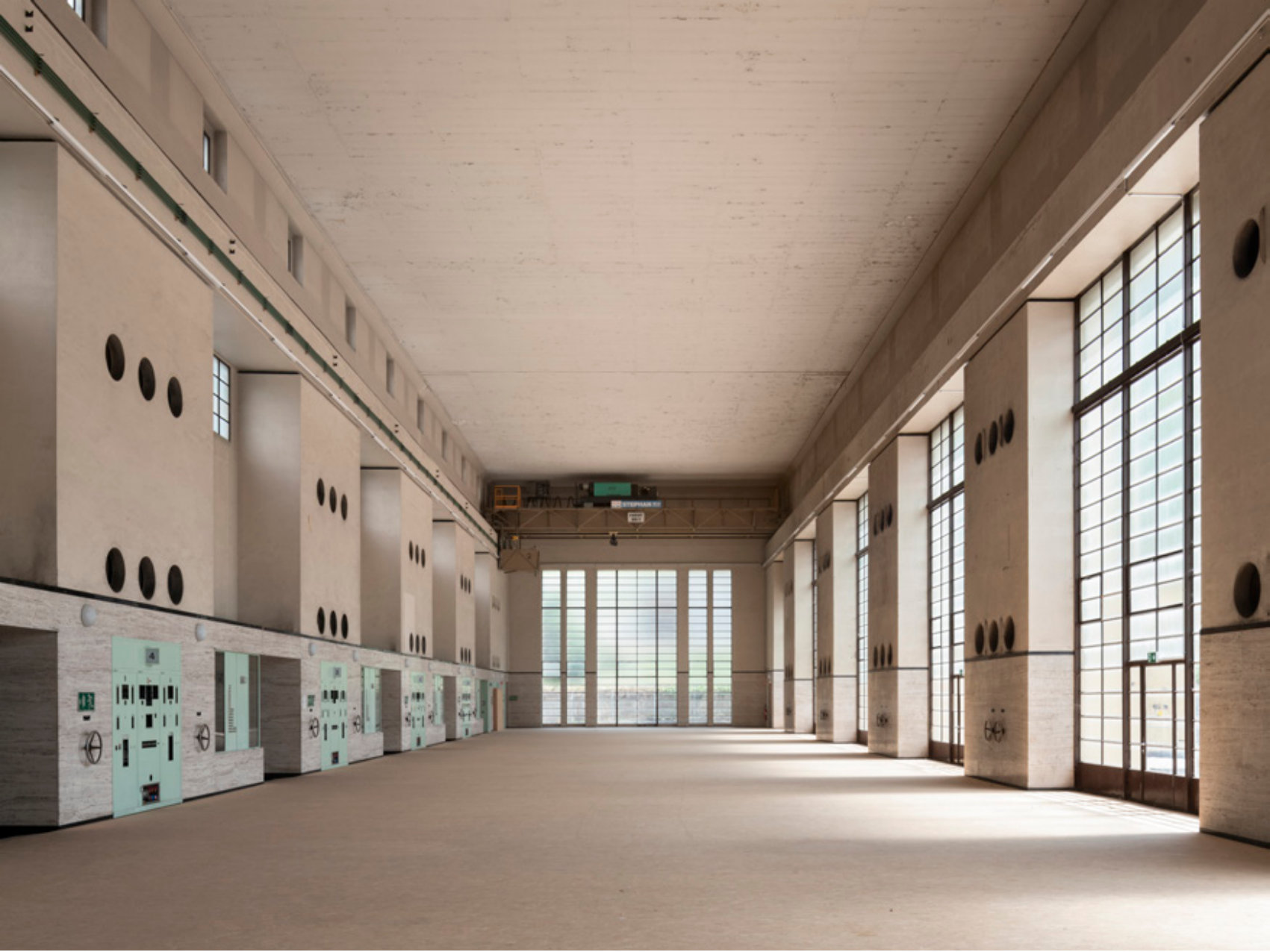 Empty machine hall with tall windows
